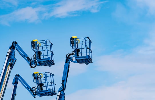 Articulated boom lift. Aerial platform lift. Telescopic boom lift against blue sky. Mobile construction crane for rent and sale. Maintenance and repair hydraulic boom lift service. Crane dealership. photo