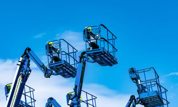 Articulated boom lift. Aerial platform lift. Telescopic boom lift against blue sky. Mobile construction crane for rent and sale. Maintenance and repair hydraulic boom lift service. Crane dealership. photo