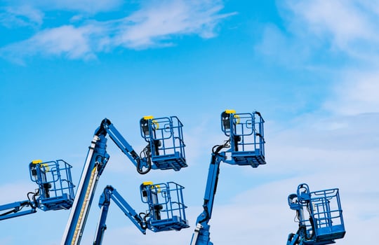 Articulated boom lift. Aerial platform lift. Telescopic boom lift against blue sky. Mobile construction crane for rent and sale. Maintenance and repair hydraulic boom lift service. Crane dealership. photo
