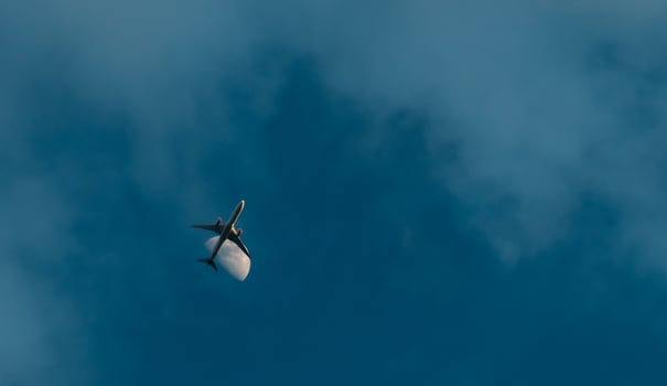 Commercial airline flying on blue sky and white clouds. Under view of airplane flying. Passenger plane after take off or going to landing flight. Summer vacation travel abroad. Air transportation. photo
