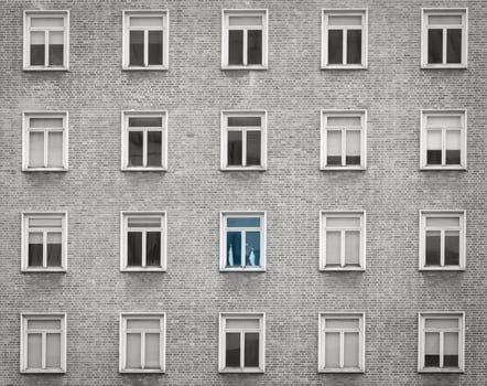 Glass window of skyscraper apartment or hotel building. Exterior brick wall of residential building. Architecture design. Window of building texture background. Gray and white vintage building. photo