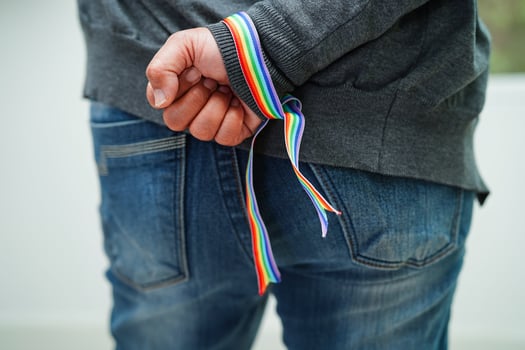 Asian woman with rainbow flag, LGBT symbol rights and gender equality, LGBT Pride Month in June. photo