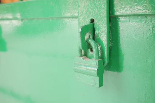 Padlock handing on a old door photo