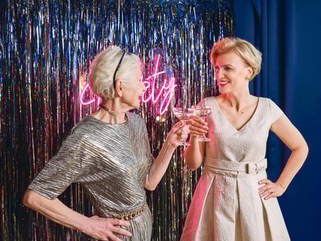 two mature women drinking sparkling wine at the party. Holidays, life event, celebration concept photo