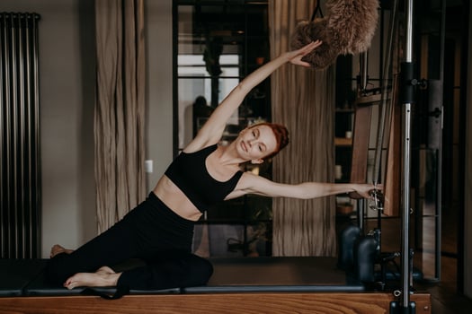 Young athletic woman during pilates training photo
