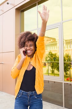 the Happy African American woman on the street talking on the phone photo
