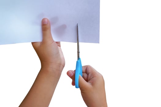 Girl is cutting paper photo