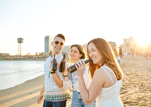 Friends drinking beer on the beach photo