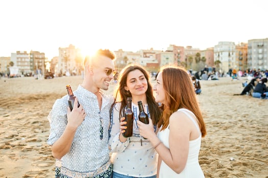 Friends drinking beer on the beach photo