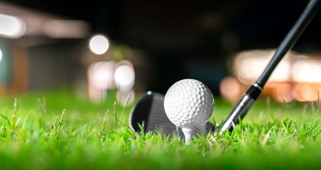 golf ball on tee in beautiful grass in golf course for shot to hole in one in competition with iron 7 photo