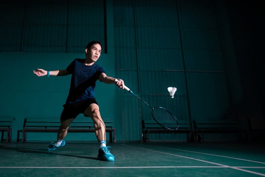 professional badminton player use racquet hit shuttle cock or shuttlecock on court during warm up play before tournament competition in single man type in indoor court photo