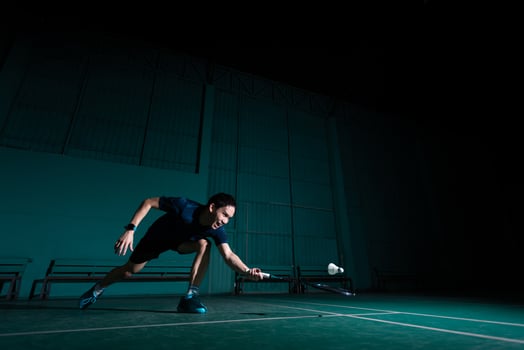 professional badminton player use racquet hit shuttle cock or shuttlecock on court during warm up play before tournament competition in single man type in indoor court photo