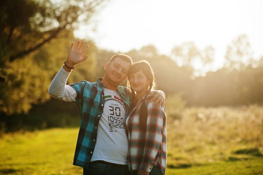 Family spending time together. Wife and husband in checkered shirts on sunset. photo