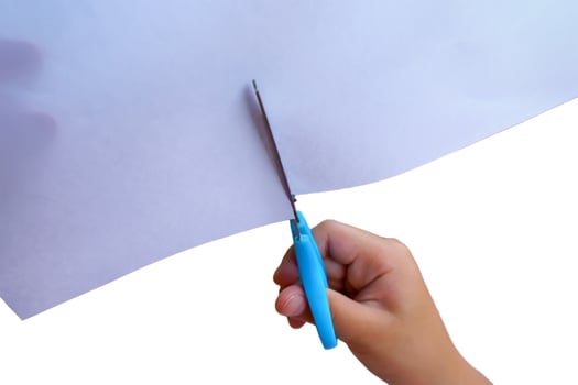 Girl is cutting paper photo