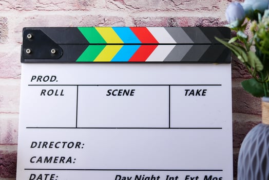 Movie clapper board against white wall photo