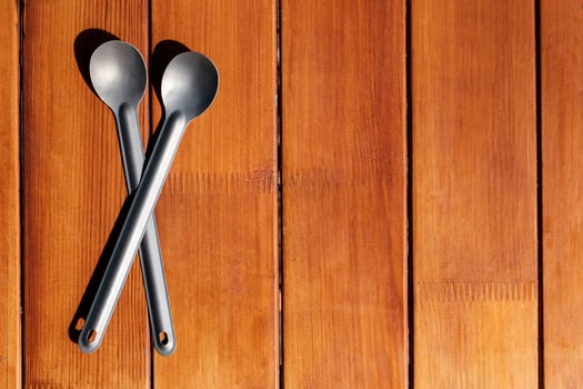 Titanium camp spoons on a wooden table photo