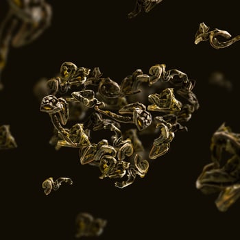 green tea leaves in flight in the shape of a heart photo