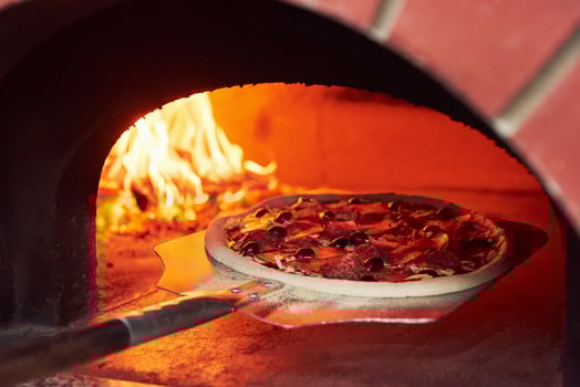 Pizza on the showel. Fire burning in the furnace. Close up view of wood in flames photo