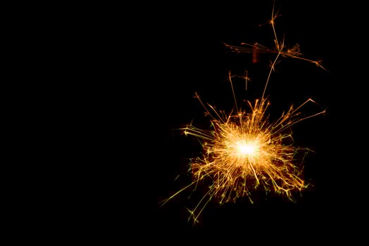 New year party sparkler on black background photo