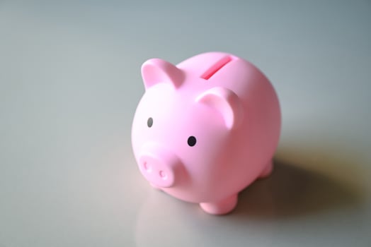 Piggy bank on floor background, pink piggy bank saving money for education study or investment concept photo