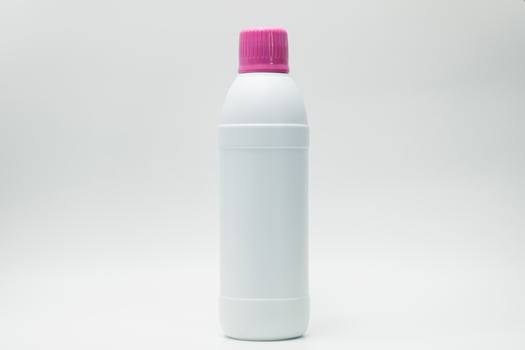 White plastic bottle with pink cap isolated on white background with copy space and blank label. Cleaning products container. Bathroom cleaner bottle.  Household Chemical bottle for cleaning toilet. photo