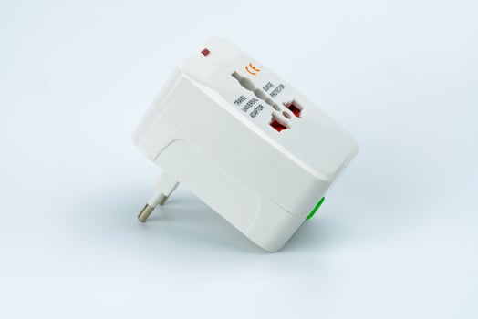 Universal plug adapters for travel around the world isolated on white background. photo