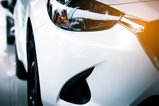 White new luxury SUV compact car parked in modern showroom for sale. Car dealership office. Car retail shop. Electric car technology and business concept photo