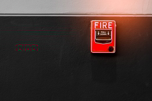 Fire alarm on black and white concrete wall. Warning and security system. Emergency equipment for safety alert. Red box of fire alarm on wall of school, hospital, factory, office, apartment, or home. photo