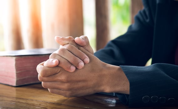 Christian man praying on the Bible, Pray and worship concept. photo