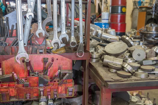 Many of spanner hang on metal hanger, untidy tools at the background photo