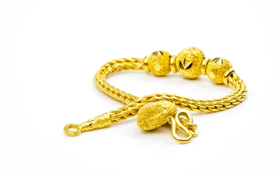 Thai style gold jewelry bracelet isolated on white background with copy space, just add your own text. Chinese New Year gift. Gold shop business. photo