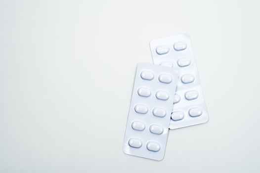 Tablets pill in white blister pack for light resistance packaging isolated on white background. Medicine for treatment NCDs. Elderly people disease. photo