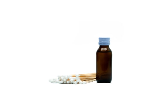 Cotton sticks and antiseptic solutions in amber glass bottle isolated on white background. Concept of Umbilical cord care for helps prevent infection. Infant's umbilical cord cleaning care equipment. photo