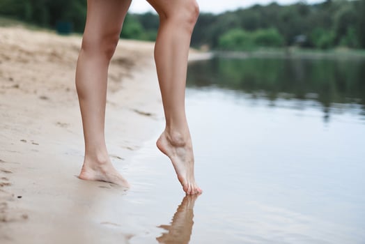 Beautiful female legs go into the water photo