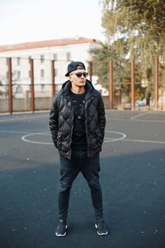 Young handsome guy in black clothes and winter jackets photo