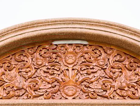 Carved lotus pattern in the traditional Thai style on the wood. photo