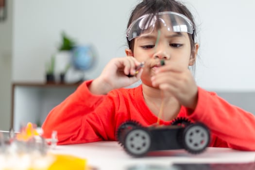 Asia students learn at home in coding robot cars and electronic board cables in STEM, STEAM, mathematics engineering science technology computer code in robotics for kids concept. photo