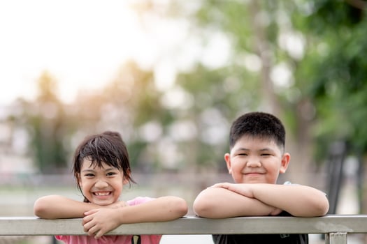 two little Asian children boy and girl Happy And smile in the park photo
