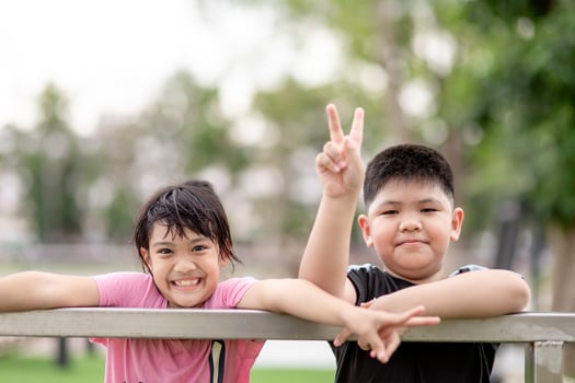 two little Asian children boy and girl Happy And smile in the park photo