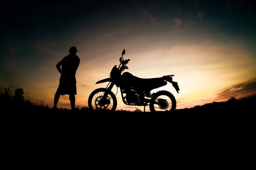 Men's silhouettes and touring motocross bikes. Park to relax in the mountains in the evening. adventure travel and leisure concept photo