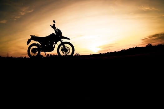 Tourist motorcycle motocross silhouette Park on the mountain in the evening. adventure travel concept photo