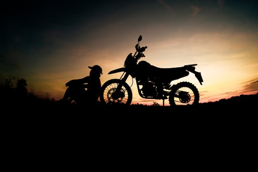 Men's silhouettes and touring motocross bikes. Park to relax in the mountains in the evening. adventure travel and leisure concept photo