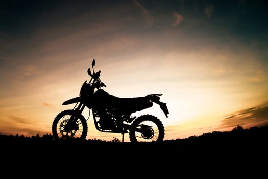 Tourist motorcycle motocross silhouette Park on the mountain in the evening. adventure travel concept photo