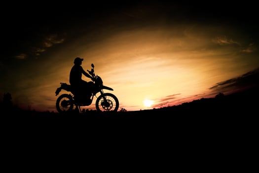Men's silhouettes and touring motocross bikes. Park to relax in the mountains in the evening. adventure travel and leisure concept photo