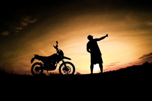 Men's silhouettes and touring motocross bikes. Park to relax in the mountains in the evening. adventure travel and leisure concept photo