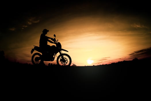 Men's silhouettes and touring motocross bikes. Park to relax in the mountains in the evening. adventure travel and leisure concept photo