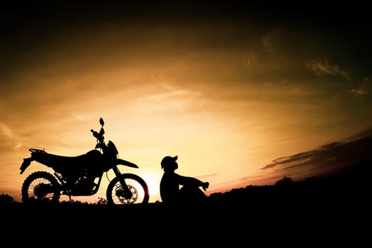 Men's silhouettes and touring motocross bikes. Park to relax in the mountains in the evening. adventure travel and leisure concept photo