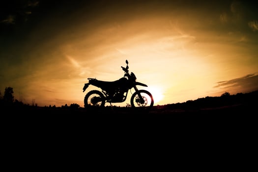 Tourist motorcycle motocross silhouette Park on the mountain in the evening. adventure travel concept photo