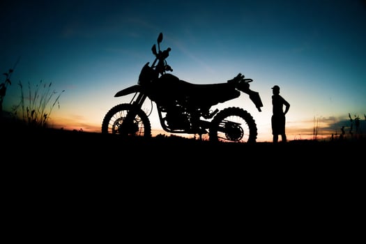 Men's silhouettes and touring motocross bikes. Park to relax in the mountains in the evening. adventure travel and leisure concept photo
