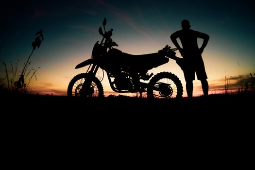 Men's silhouettes and touring motocross bikes. Park to relax in the mountains in the evening. adventure travel and leisure concept photo
